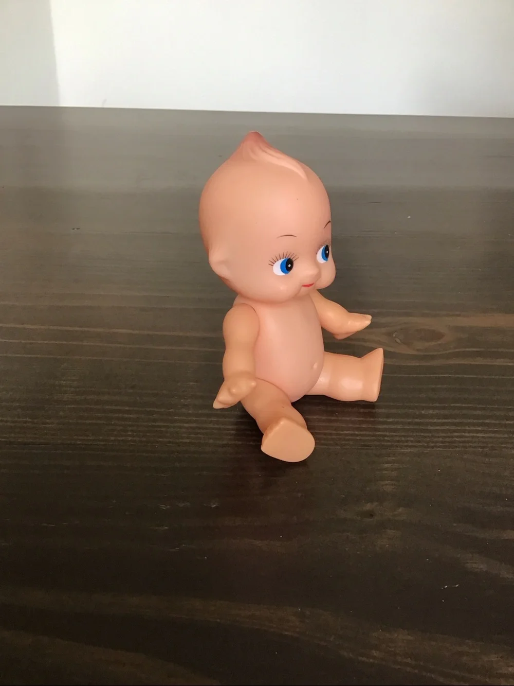 Vintage unmarked 6-inch hard plastic Kewpie doll from the mid-century era